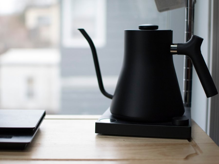 Gooseneck kettle pouring water over a pour-over dripper