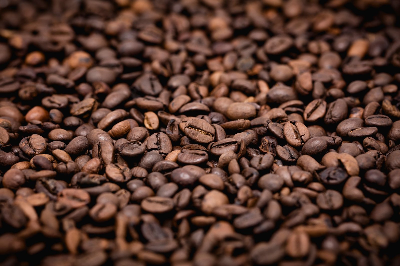 Artistic macro close-up of dense roasted coffee beans